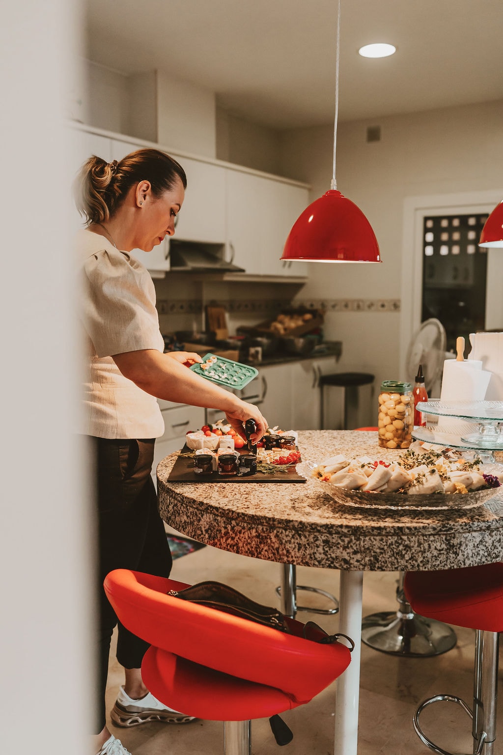 Angelika preparing food in a bright villa kitchen