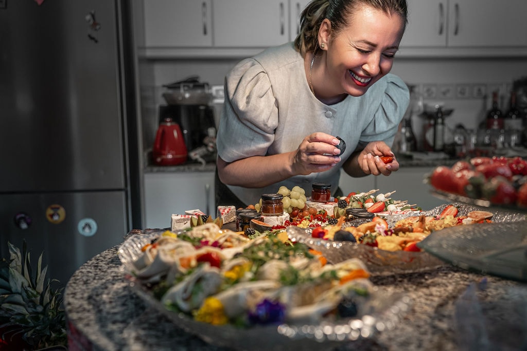 Angelika carefully plating a grazing platter