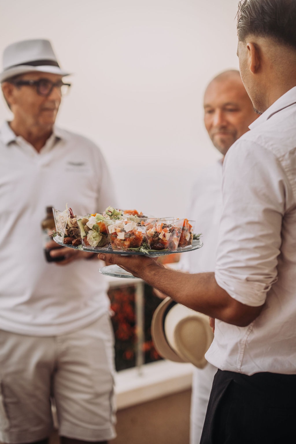 A server offering canapés to guests on the terrace