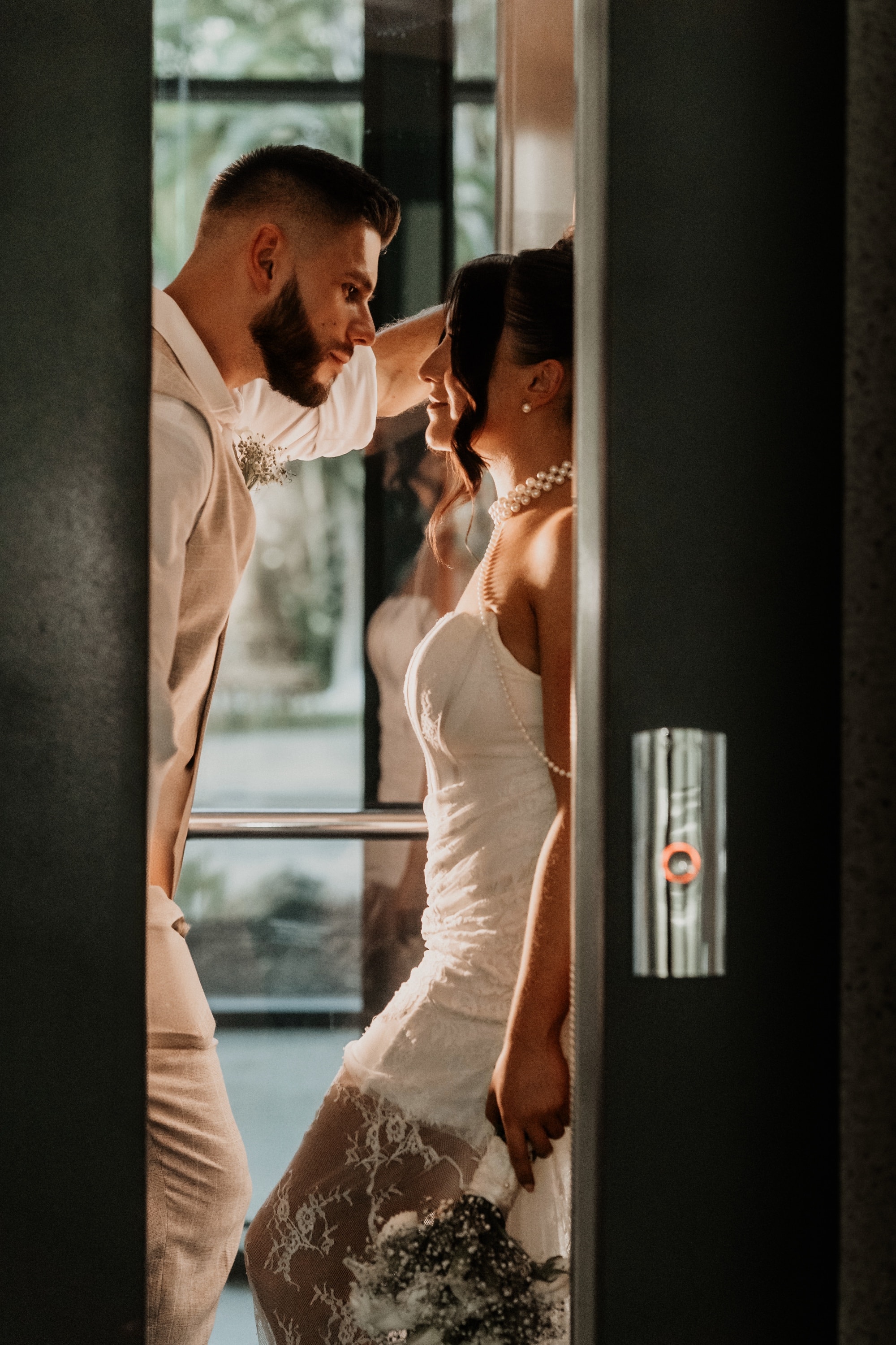 A bride and groom sharing a moment in a doorway