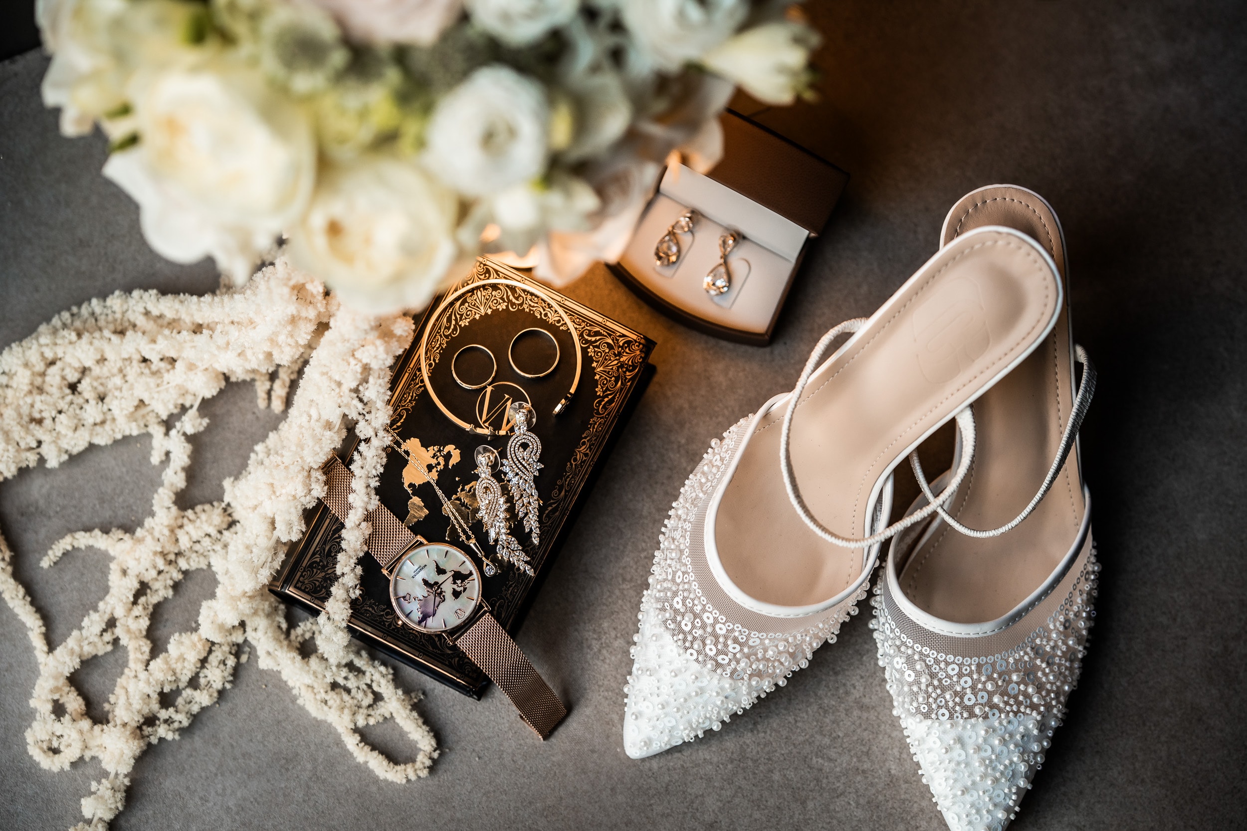 Wedding details: bridal shoes, jewellery and white flowers